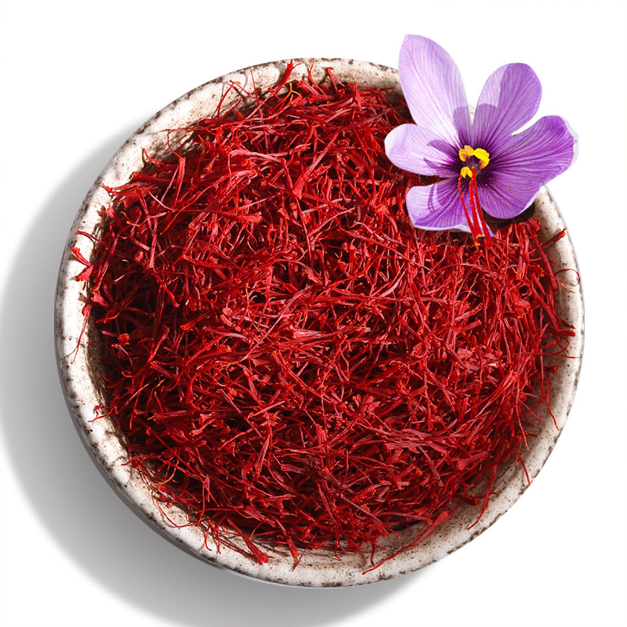 Golden saffron infusion in a glass bowl with a spoon of threads